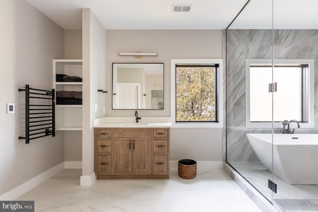 bathroom featuring vanity and shower with separate bathtub