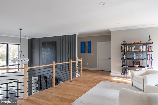 interior space featuring hardwood / wood-style flooring, ornamental molding, and a chandelier