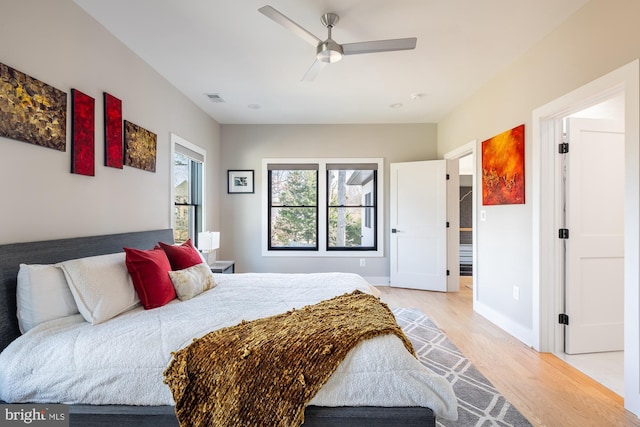 bedroom with ceiling fan and light wood-type flooring