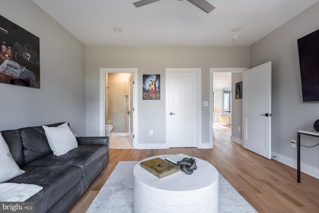 living room with ceiling fan and light hardwood / wood-style floors