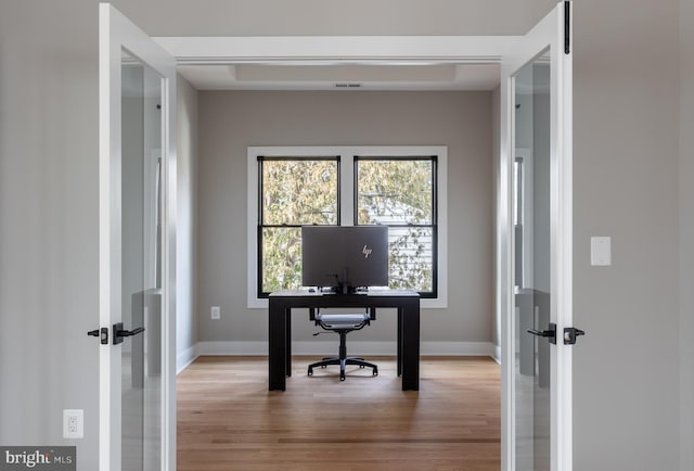 office area featuring light hardwood / wood-style floors and french doors