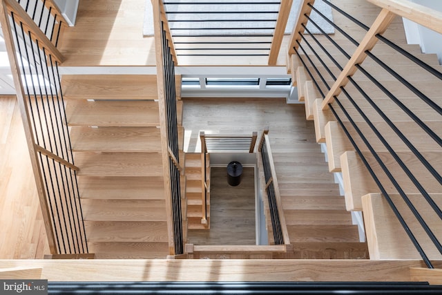 stairway featuring wood-type flooring