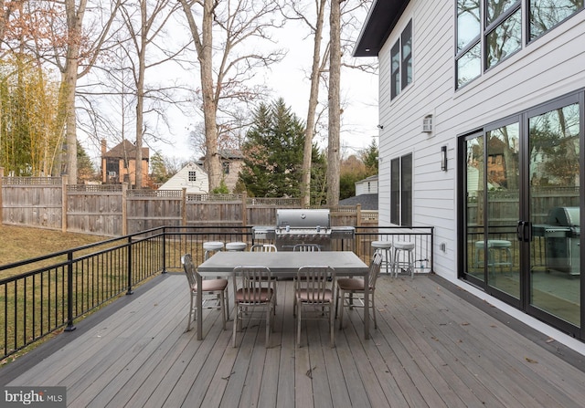 wooden terrace featuring a grill and an outdoor bar