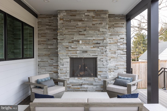 view of patio with an outdoor living space with a fireplace