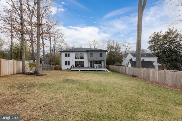 rear view of property with a yard and a deck