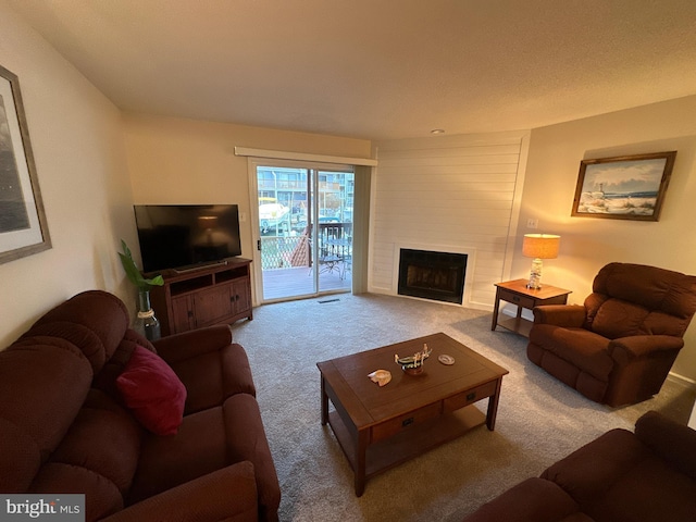 carpeted living room with a large fireplace