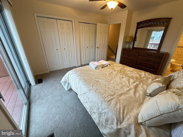 bedroom with ceiling fan, multiple closets, and carpet