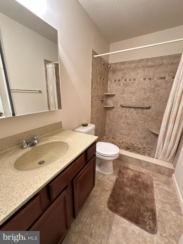 bathroom with vanity, a textured ceiling, a shower with curtain, and toilet