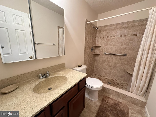 bathroom with vanity, curtained shower, a textured ceiling, and toilet