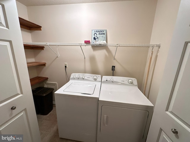 laundry area with tile patterned flooring and washing machine and dryer