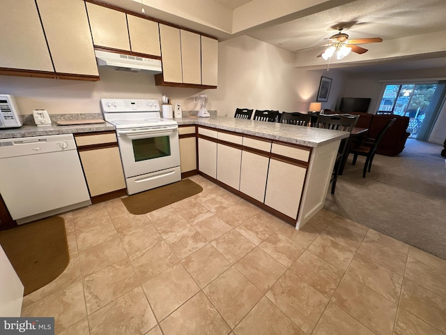 kitchen featuring ceiling fan, light carpet, white appliances, and kitchen peninsula