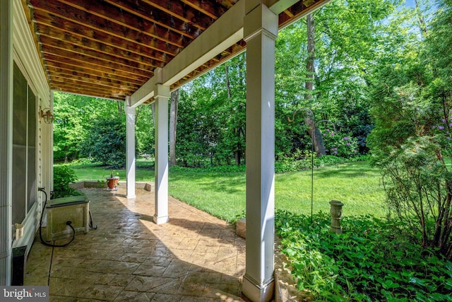 view of patio / terrace featuring view of wooded area