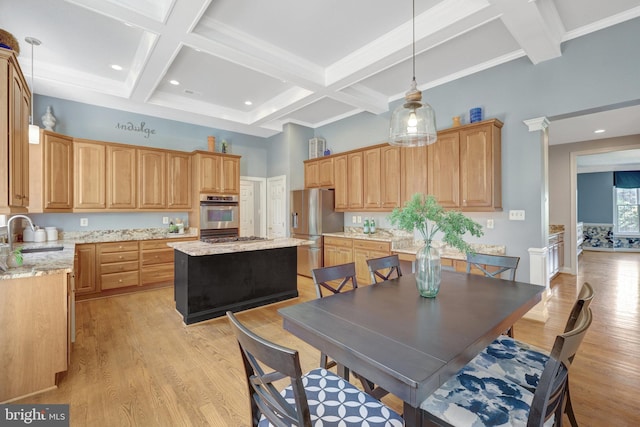 dining space featuring coffered ceiling, beam ceiling, light wood-type flooring, and a high ceiling
