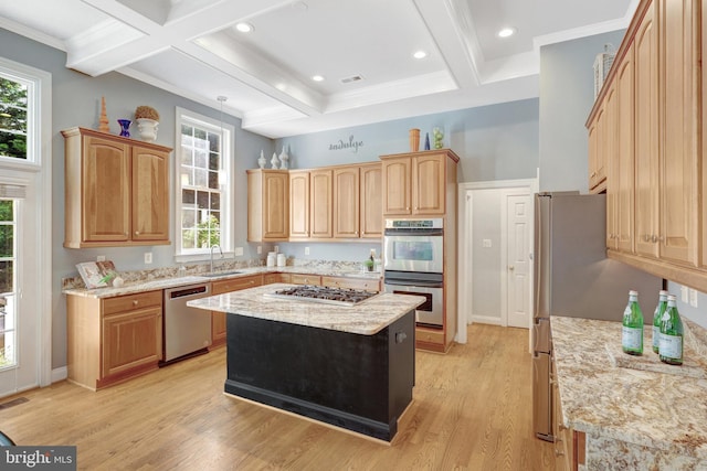 kitchen featuring stainless steel appliances, coffered ceiling, light wood-style flooring, beamed ceiling, and plenty of natural light