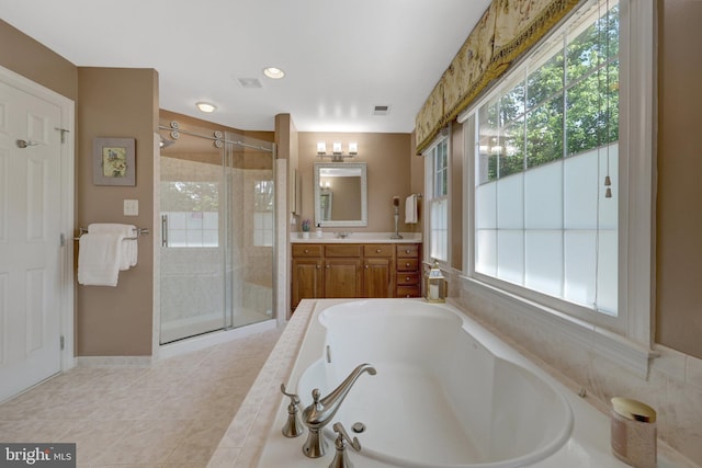 full bathroom featuring a bath, a stall shower, healthy amount of natural light, and vanity