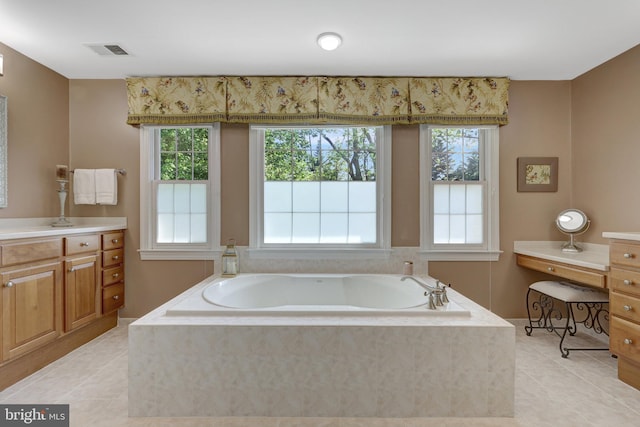 bathroom with tile patterned flooring, vanity, and healthy amount of natural light