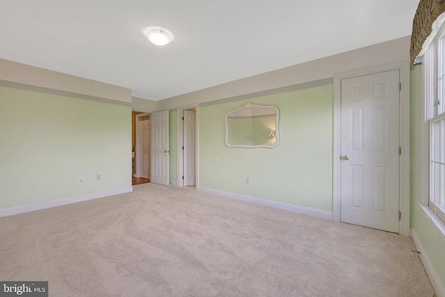 unfurnished bedroom with carpet and baseboards