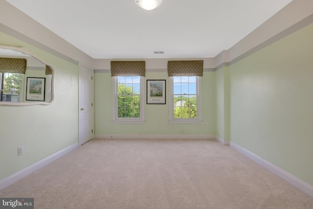 carpeted empty room with baseboards