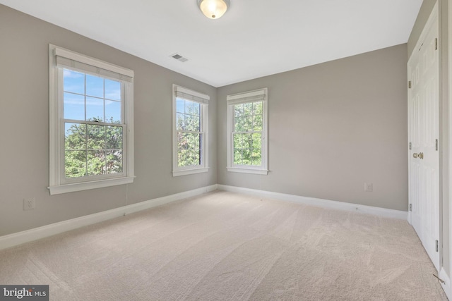 unfurnished bedroom with light carpet and baseboards