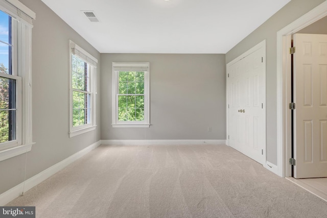unfurnished room featuring carpet and baseboards