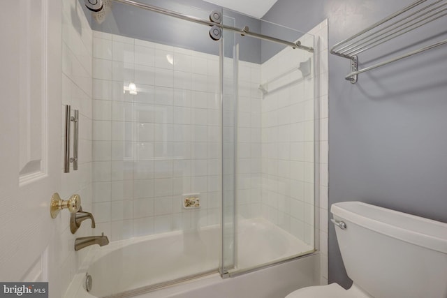 full bath featuring toilet and bath / shower combo with glass door