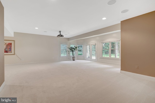unfurnished living room featuring carpet flooring, healthy amount of natural light, baseboards, and recessed lighting