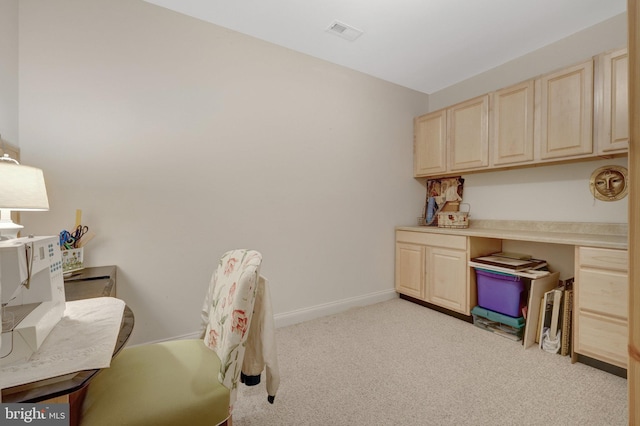 office area with light carpet and baseboards