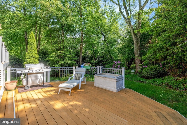 wooden terrace with a grill