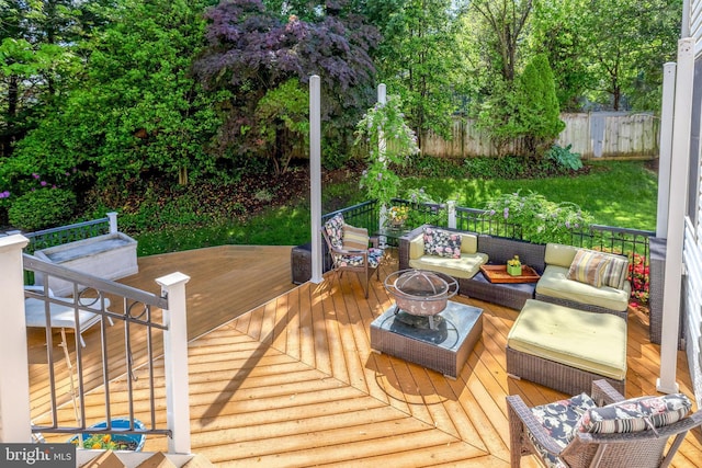 wooden terrace with an outdoor living space with a fire pit and fence