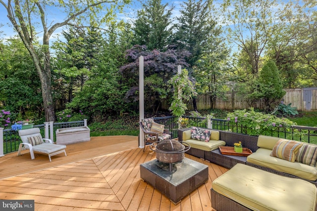 deck featuring outdoor lounge area and a fenced backyard