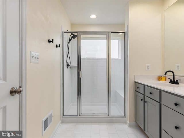 bathroom featuring vanity and an enclosed shower