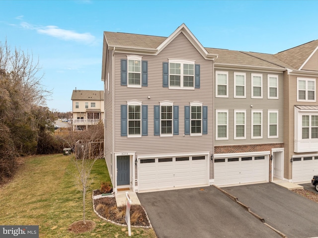 view of property with a garage and a front lawn