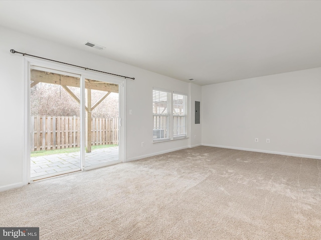 empty room featuring electric panel and carpet flooring