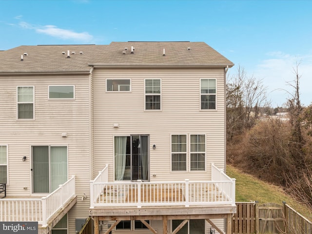 rear view of house featuring a wooden deck