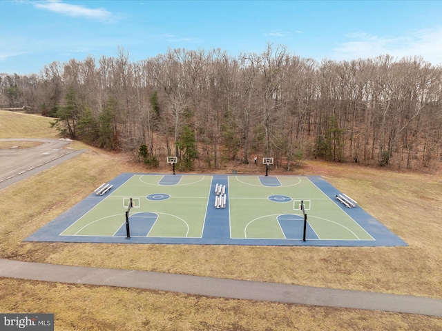 view of sport court with a yard