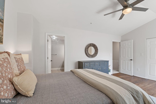 bedroom featuring vaulted ceiling, wood finished floors, and a ceiling fan