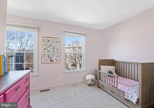 carpeted bedroom featuring visible vents and baseboards