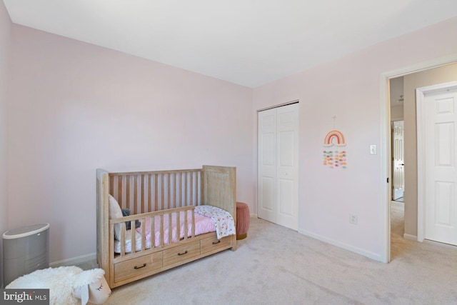 bedroom with a closet, carpet flooring, and baseboards