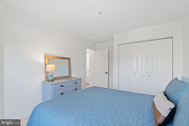 bedroom featuring carpet floors, a closet, and attic access