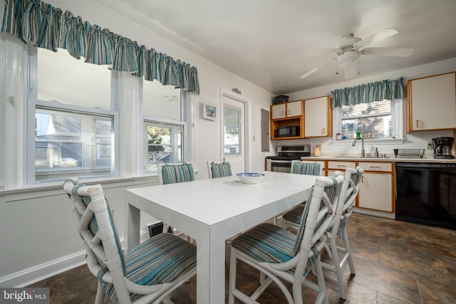 dining area with ceiling fan and sink