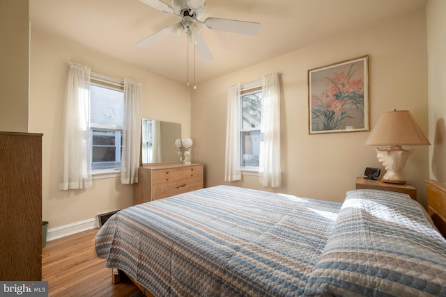 bedroom with ceiling fan and light wood-type flooring