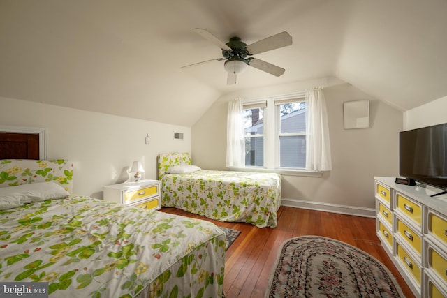 bedroom with dark hardwood / wood-style flooring, lofted ceiling, and ceiling fan