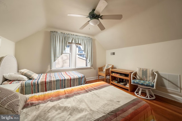 bedroom with ceiling fan, lofted ceiling, and hardwood / wood-style floors