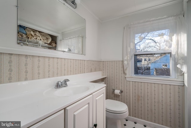 bathroom featuring vanity, crown molding, and toilet