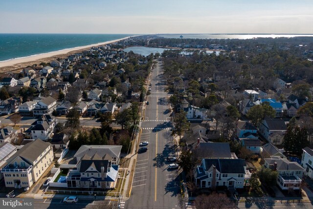 drone / aerial view featuring a water view and a beach view