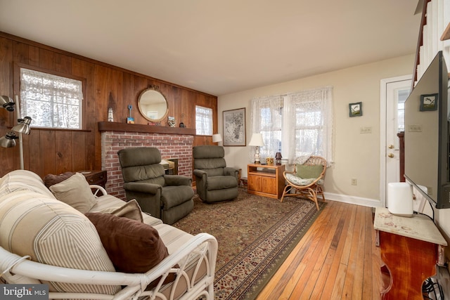 living room featuring hardwood / wood-style floors and wooden walls