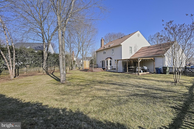 view of yard featuring fence, a deck, and a patio