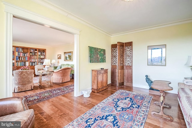 sitting room featuring crown molding and hardwood / wood-style flooring