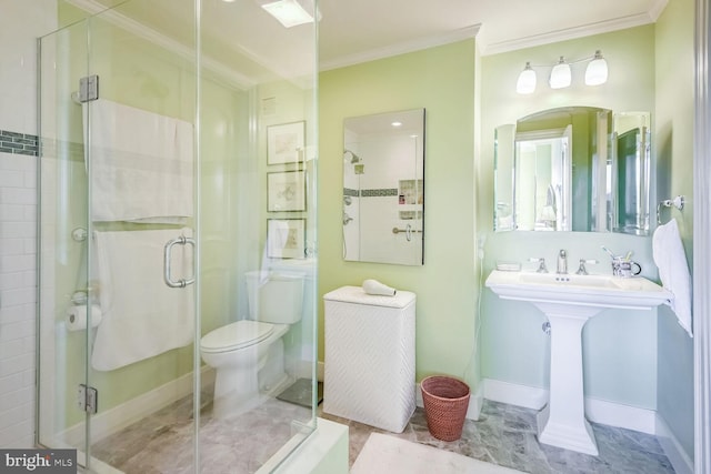 bathroom with ornamental molding, toilet, and a shower with shower door