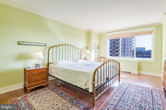 bedroom with hardwood / wood-style floors, crown molding, and radiator heating unit